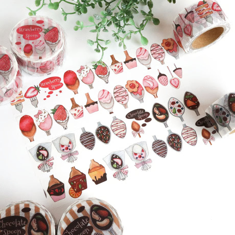Decorative tape with dessert-themed designs on a white surface with greenery.
