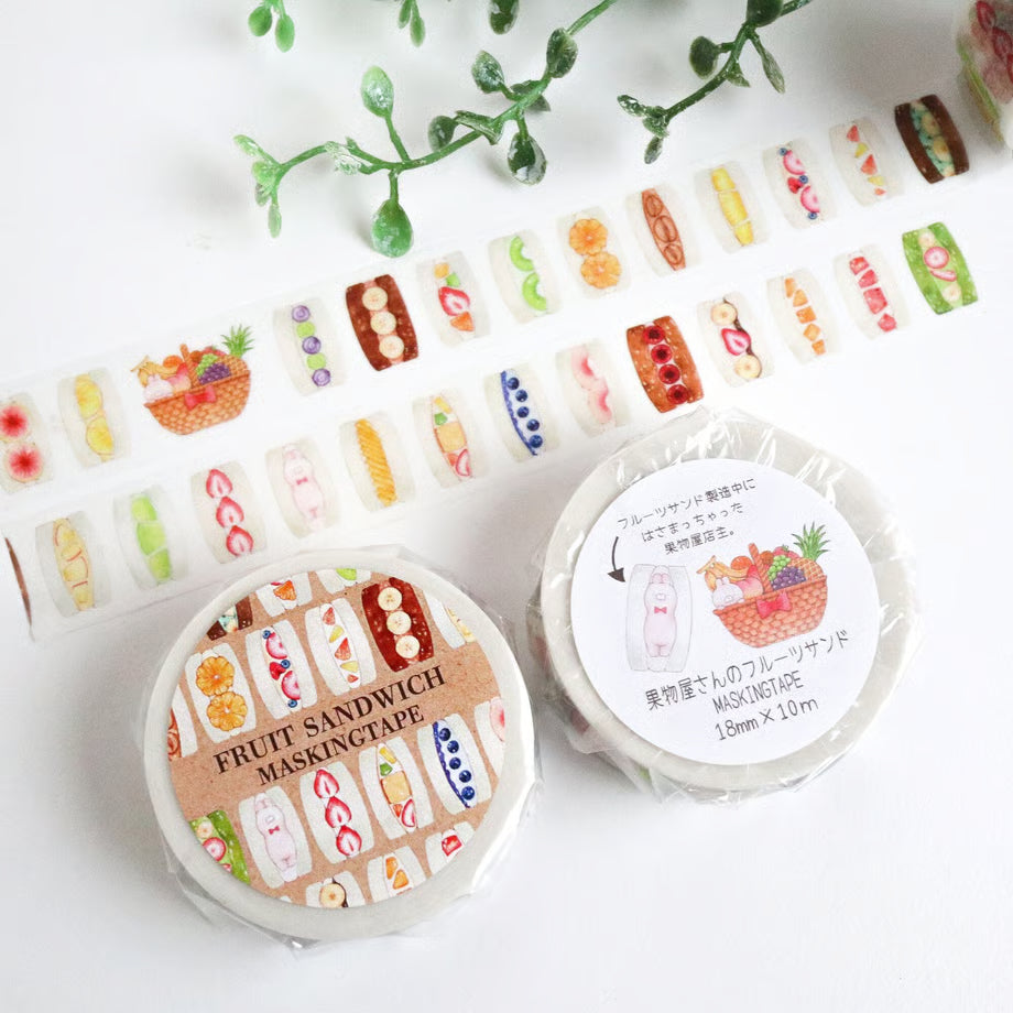 Fruit-themed masking tape rolls on a white background with greenery.