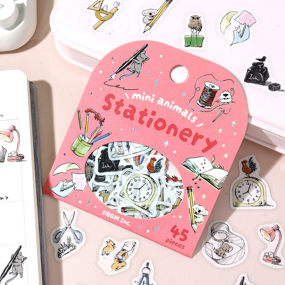 Pink stationery set packaging with illustrations of small animals and stationery items on a light pink background.