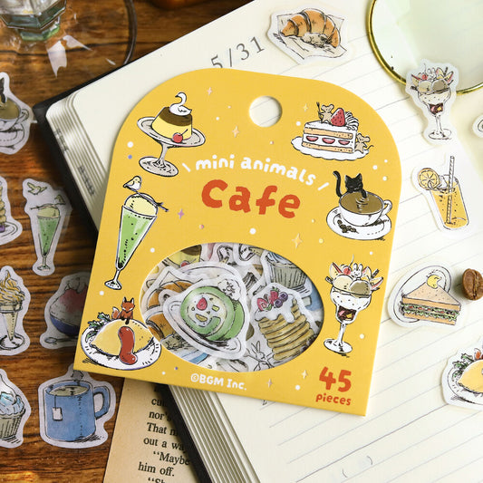 Pack of mini animal-themed cafe stickers with a yellow card on a wooden surface.