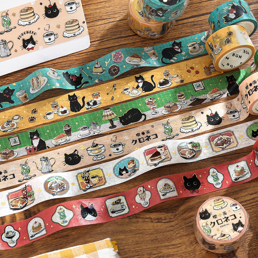Set of decorative tape rolls with cat and food illustrations on a wooden surface