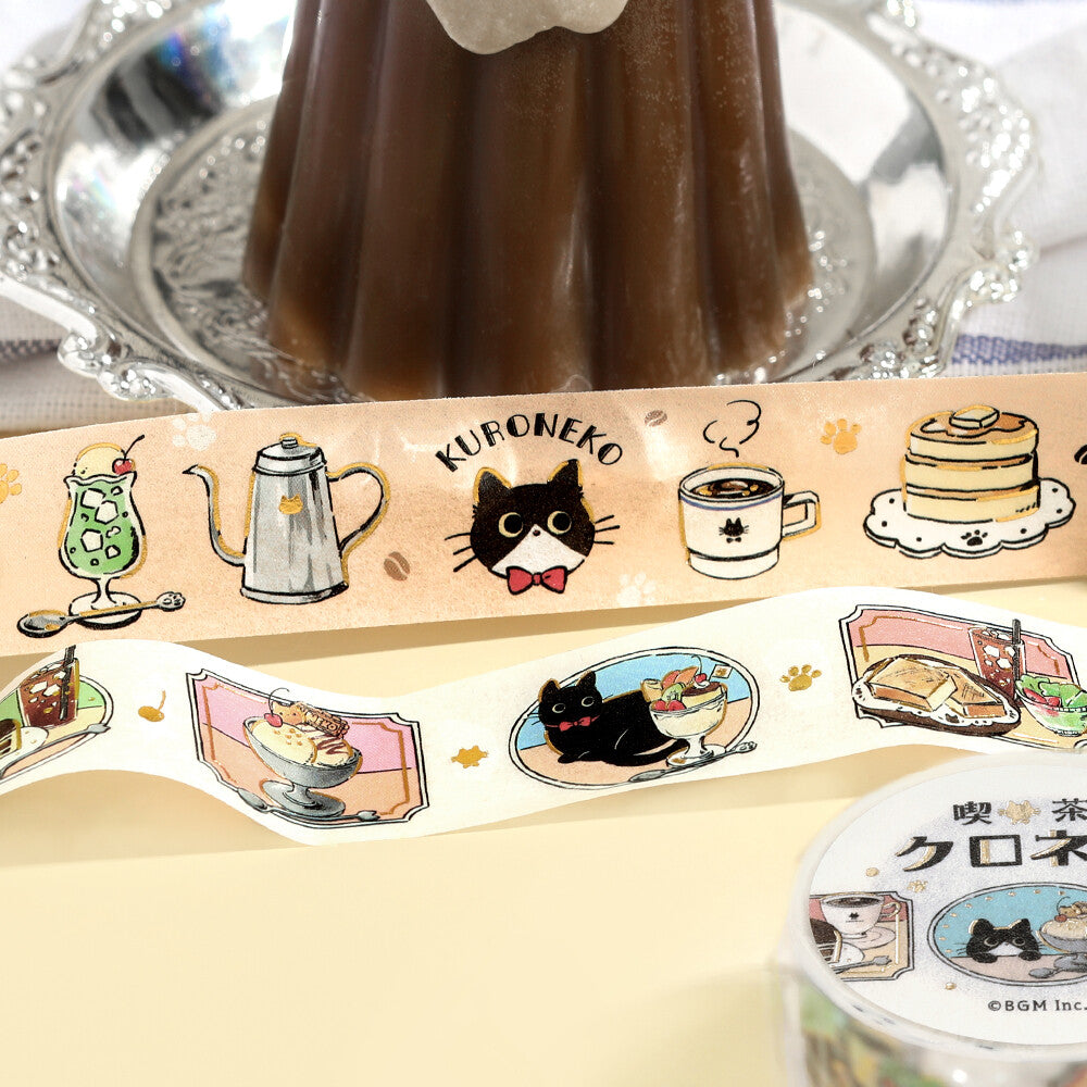 Decorative tape with cat-themed designs on a reflective surface