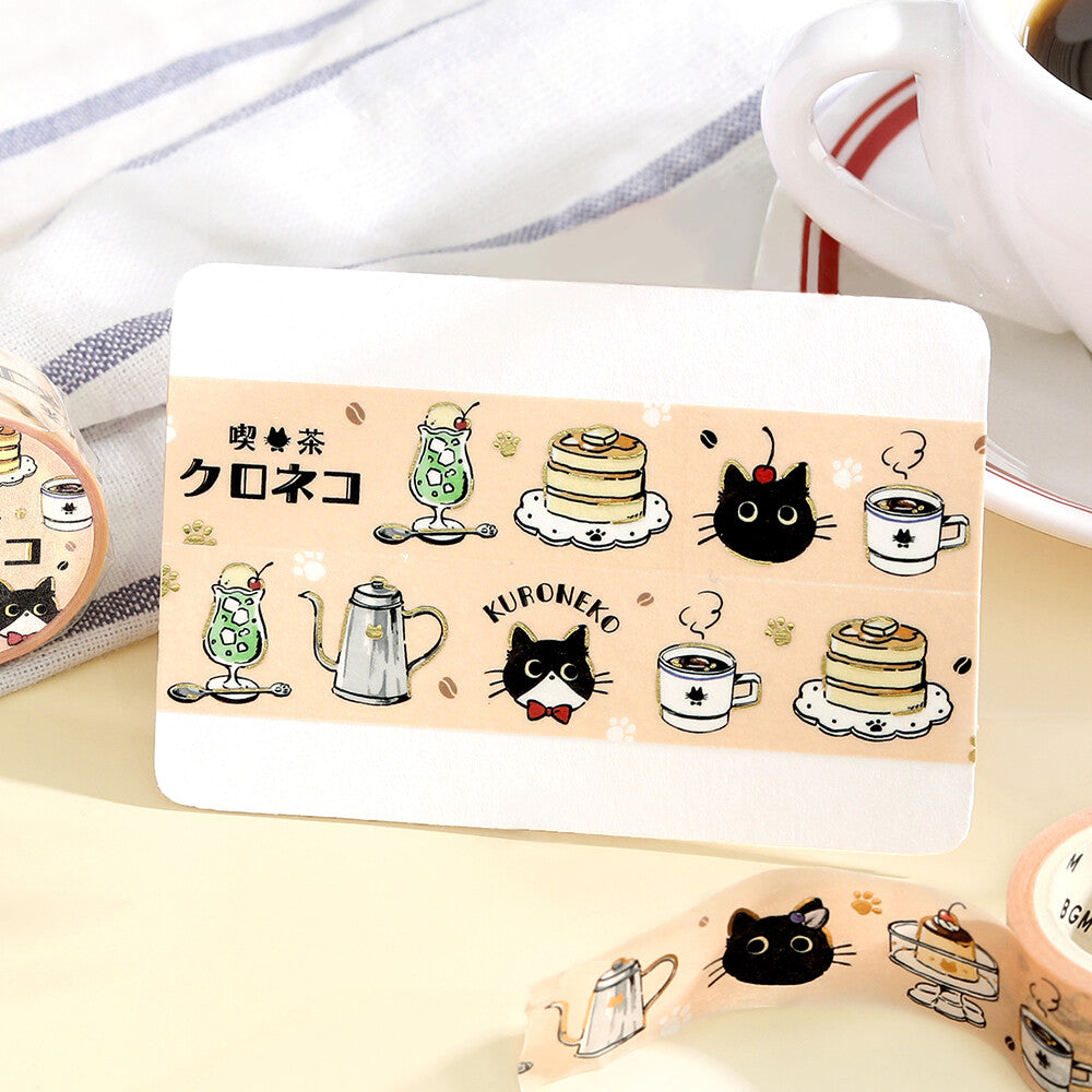 Kawaii-themed card with illustrations of cats, tea, and cakes on a light surface.
