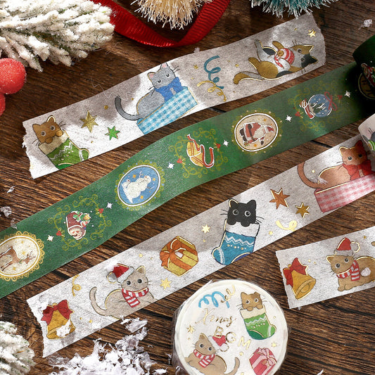 Decorative washi tape strips with festive cat illustrations on a wooden surface.