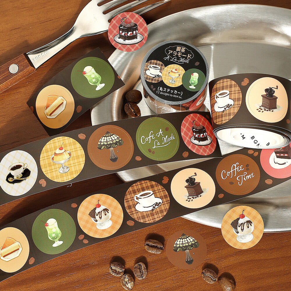 Decorative coasters with coffee-themed illustrations on a wooden surface with a knife and fork.