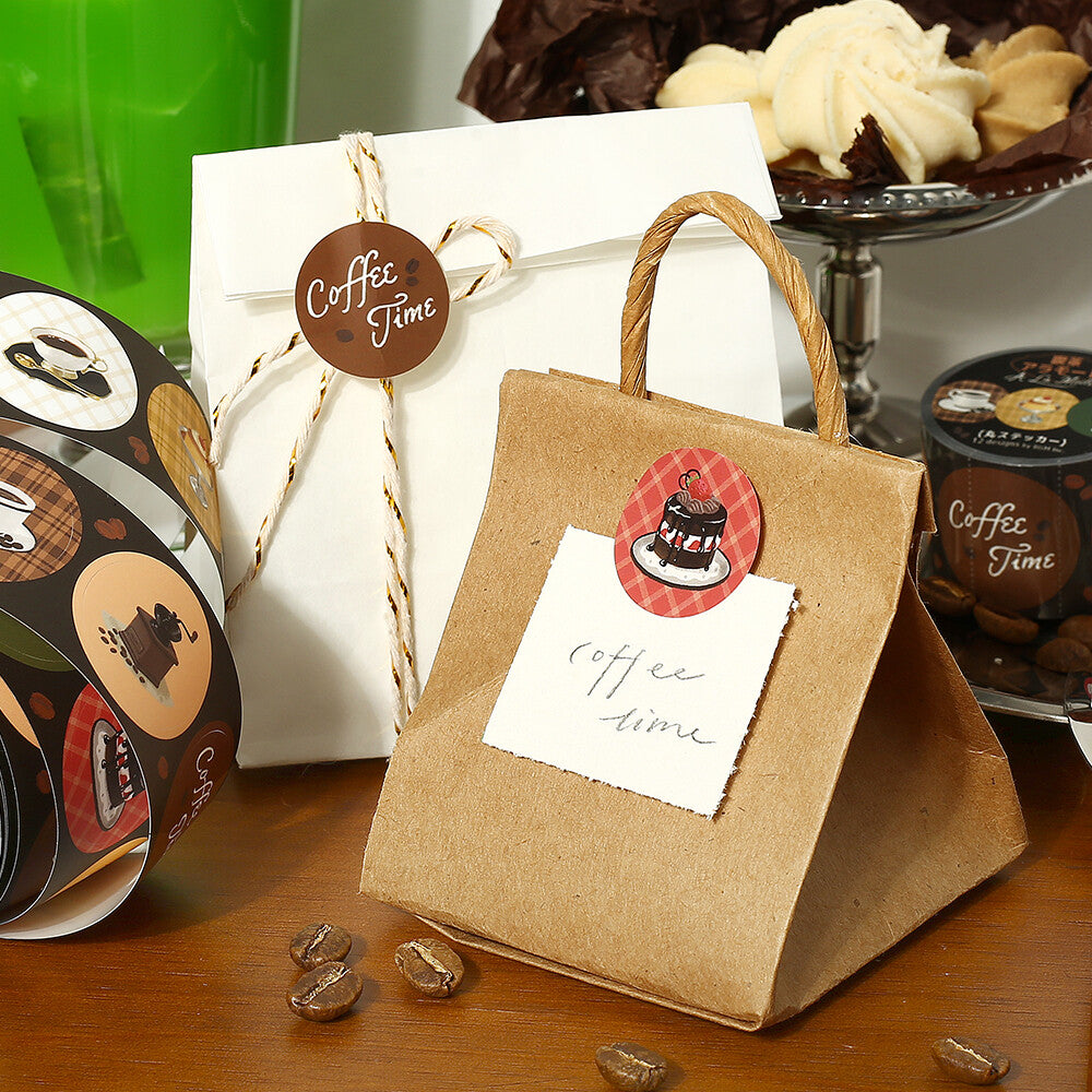 Kraft paper gift bag with 'Coffee Time' tag on a wooden surface with coffee-themed items.