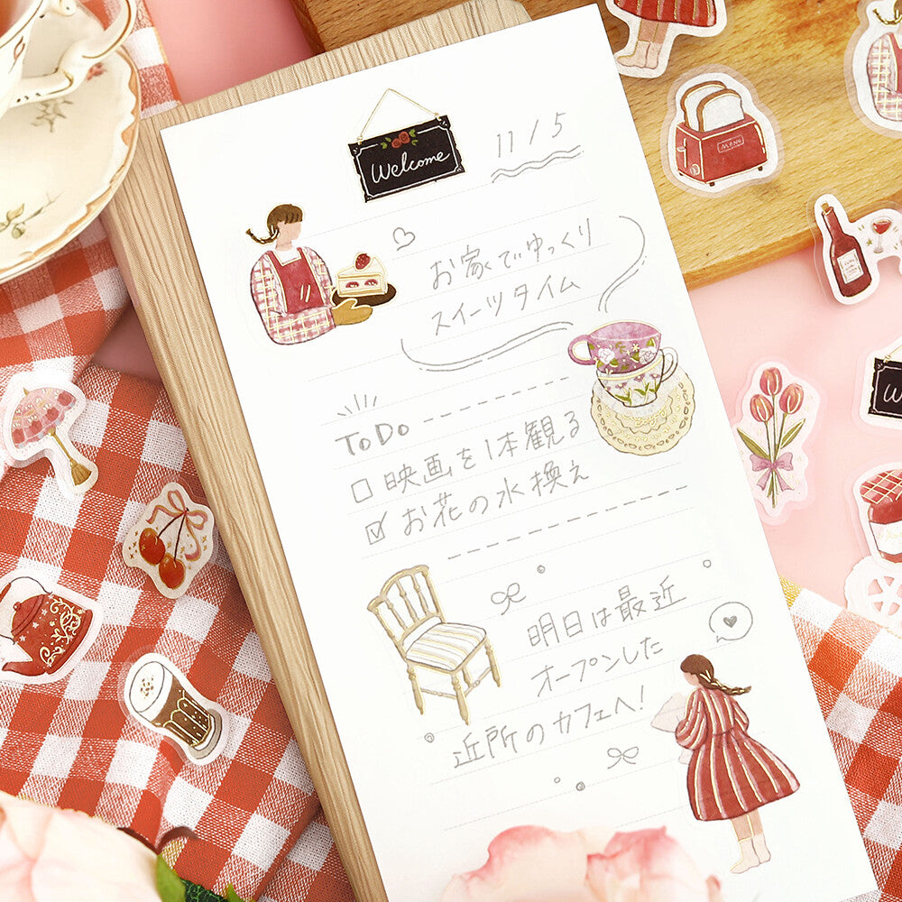 Sheet of stickers with illustrations and text on a checkered surface