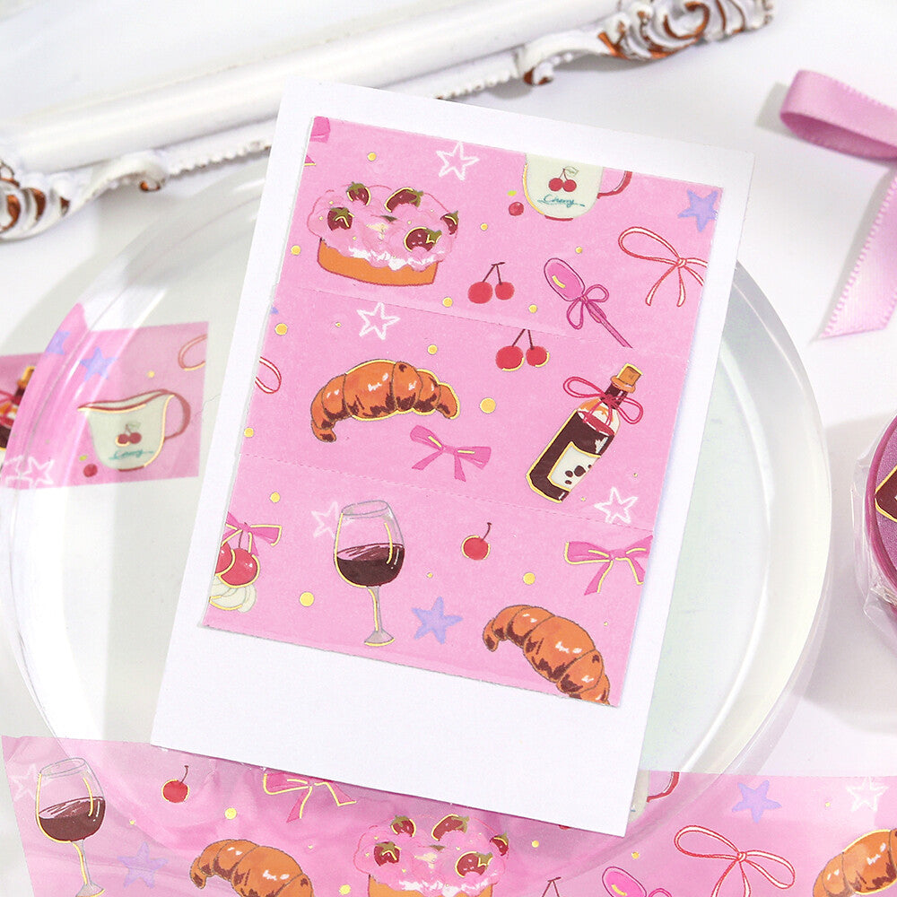 Pink patterned paper with food illustrations on a white surface
