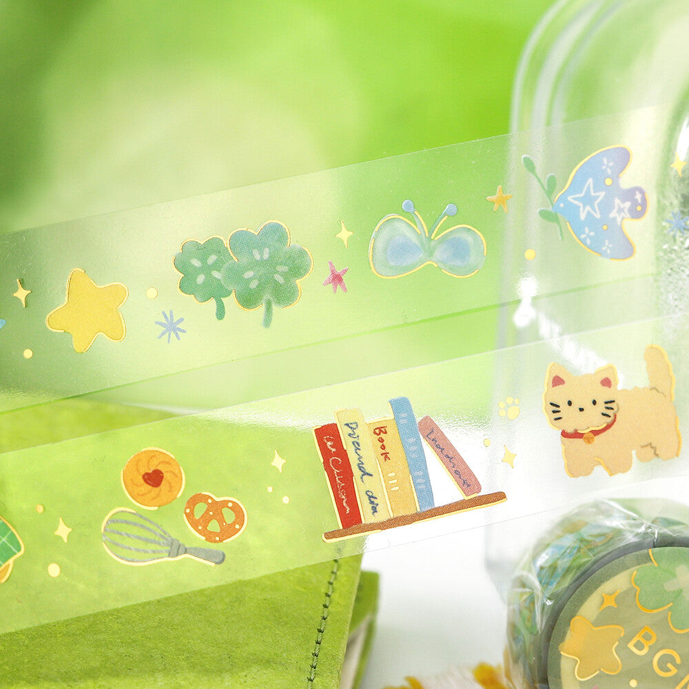 Set of decorative tape rolls with cartoon designs on a green background