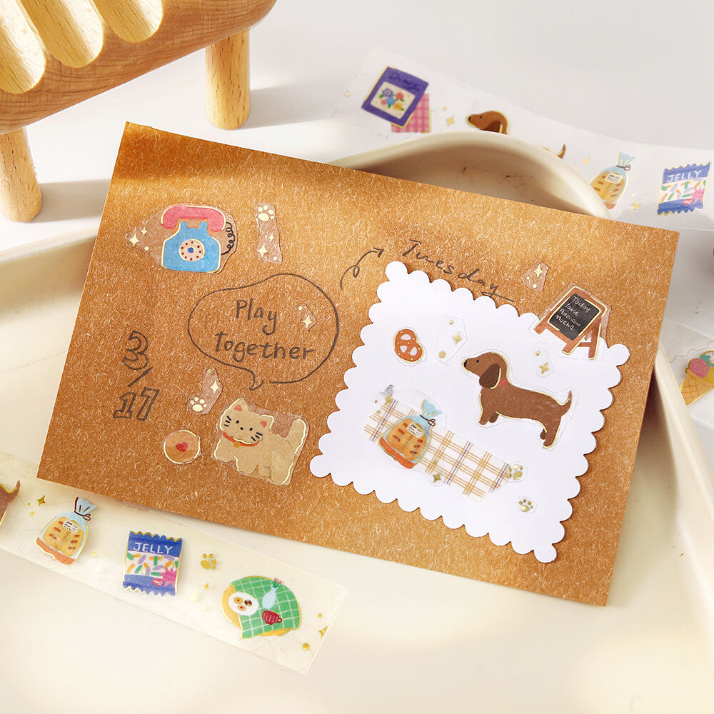 Brown paper bag with decorative stickers featuring a dog and cat, on a light wooden surface.