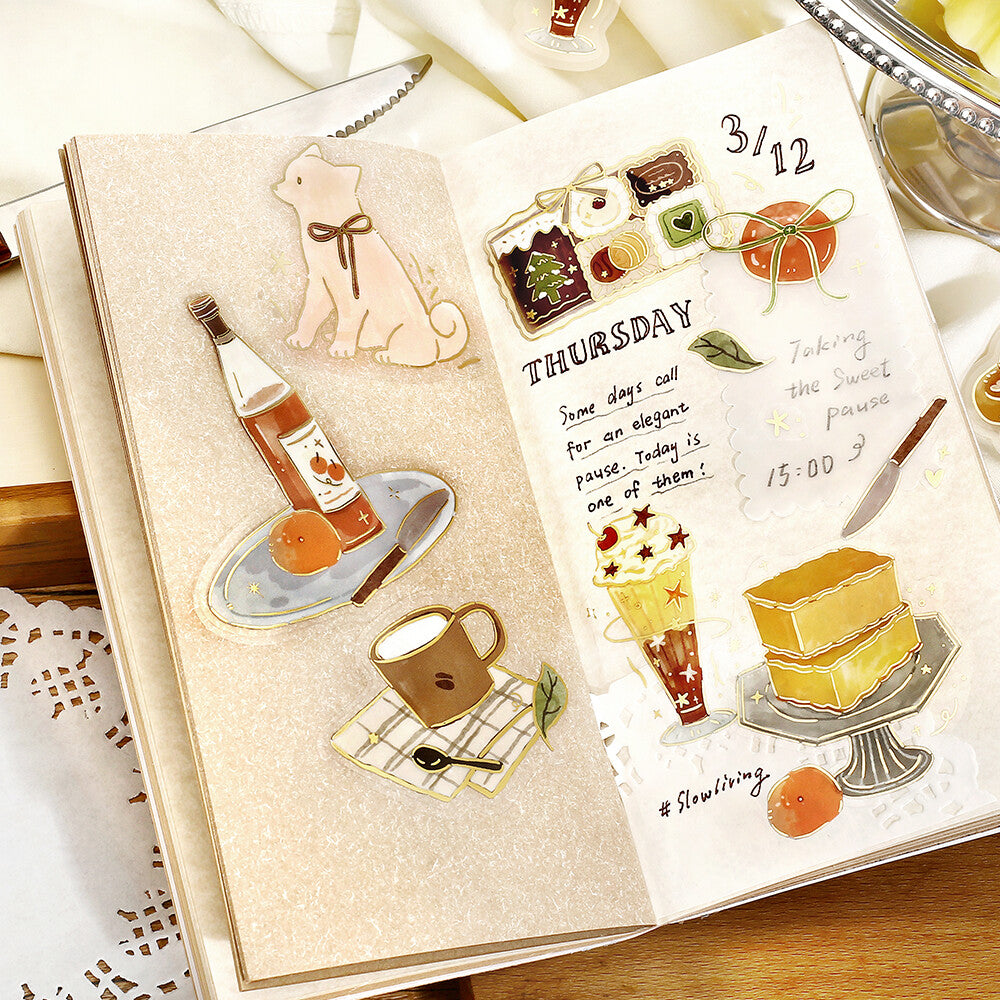Decorative planner with food-themed stickers and a date on a wooden surface.