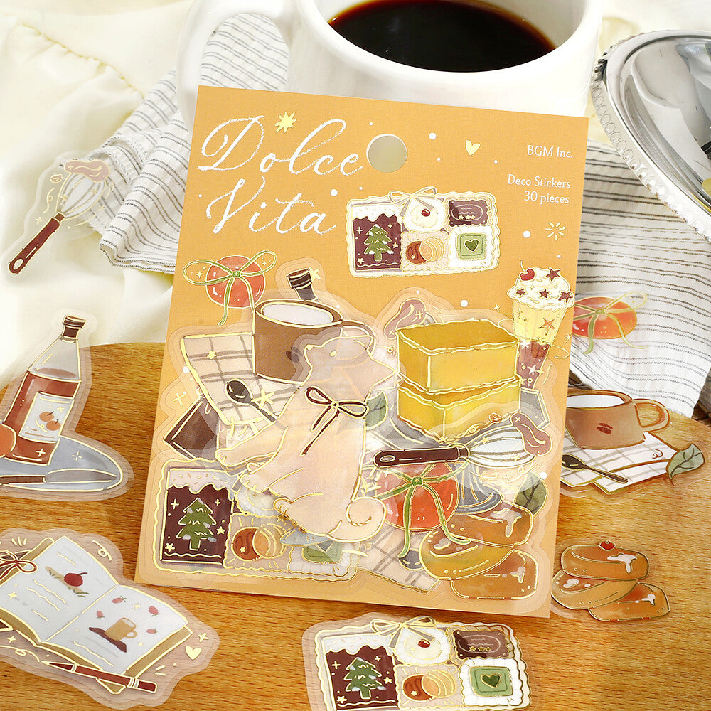 Dolce Vita sticker sheet with illustrations on a wooden surface with a cup of coffee.