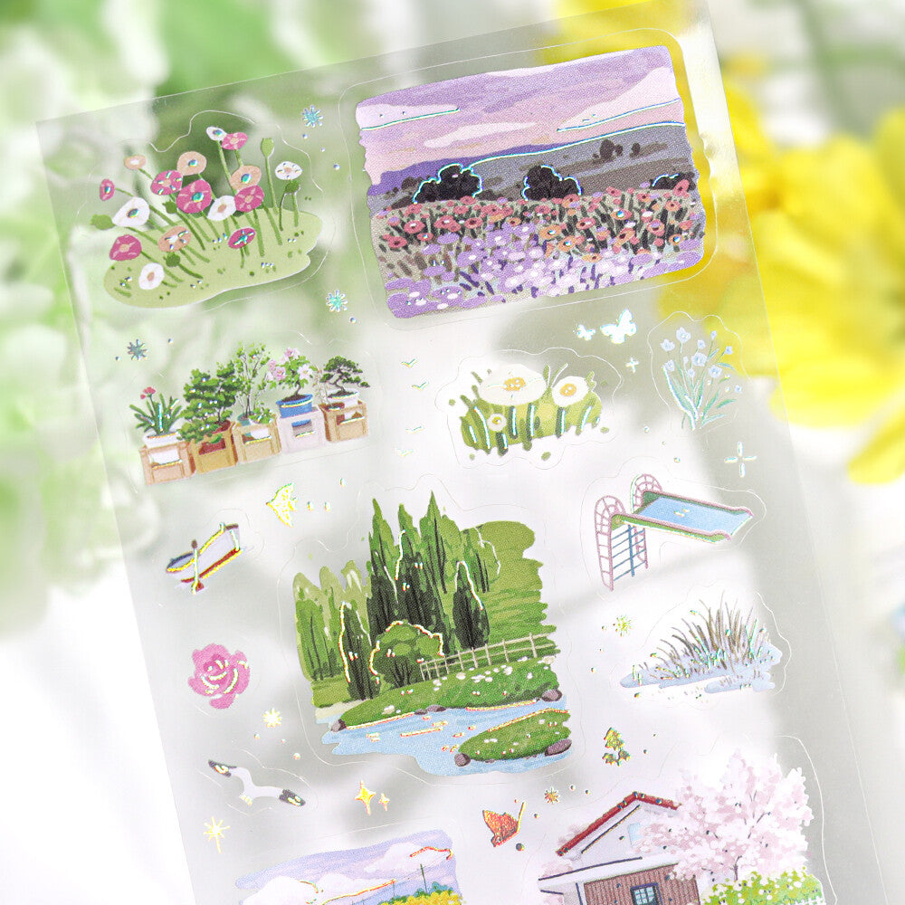 Set of garden-themed stickers in a clear packaging on a blurred natural background