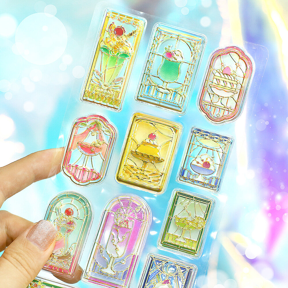 Set of colorful card-style stickers held by a hand with a sparkling background