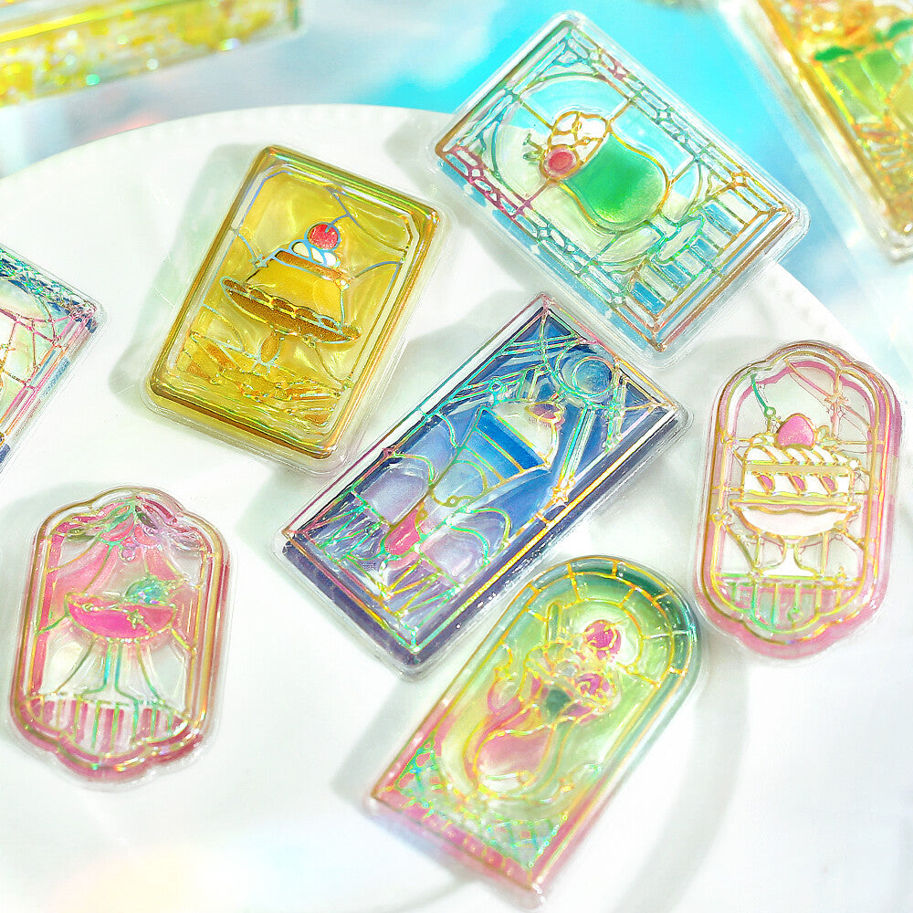 Iridescent card-like objects with colorful designs on a white surface
