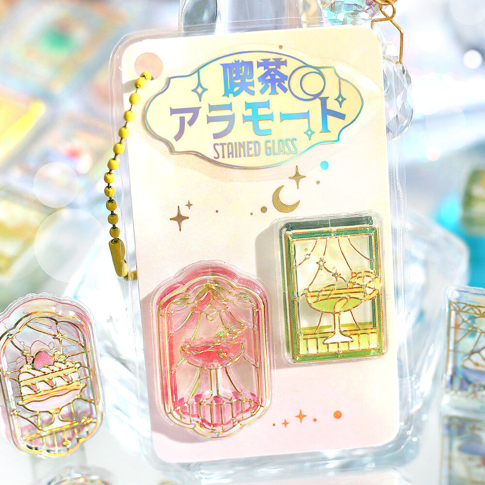 Stained glass-themed phone charm with packaging on a colorful, blurred background