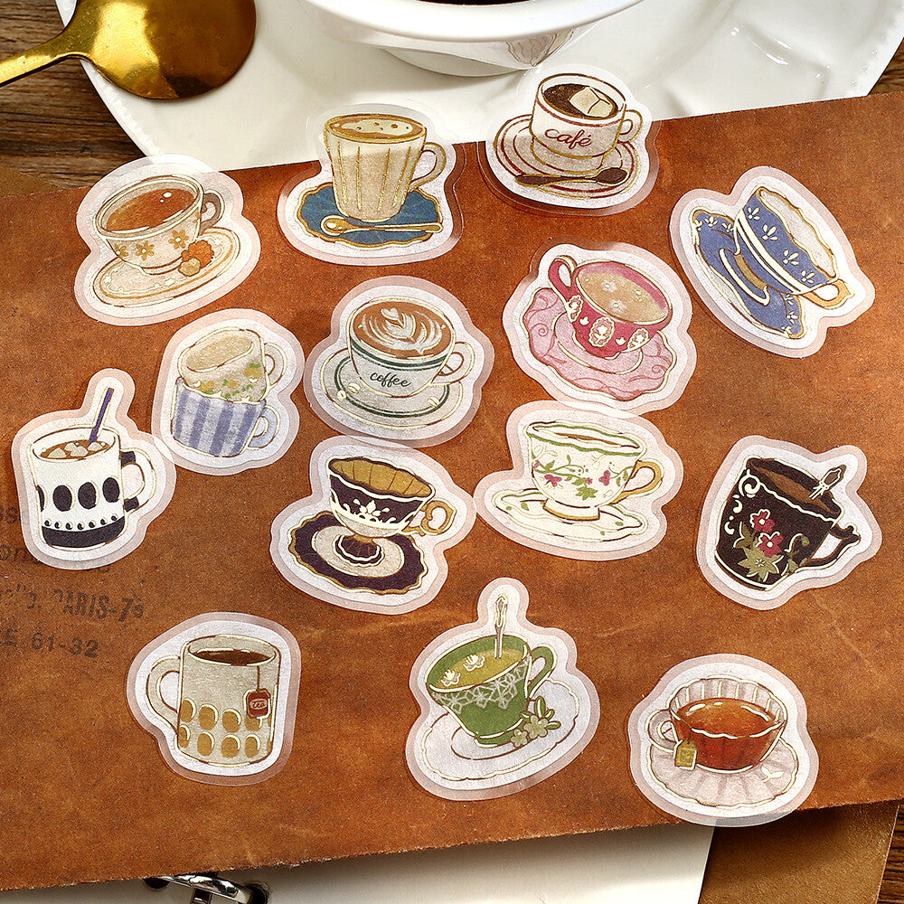 Collection of coffee-themed stickers on a wooden surface