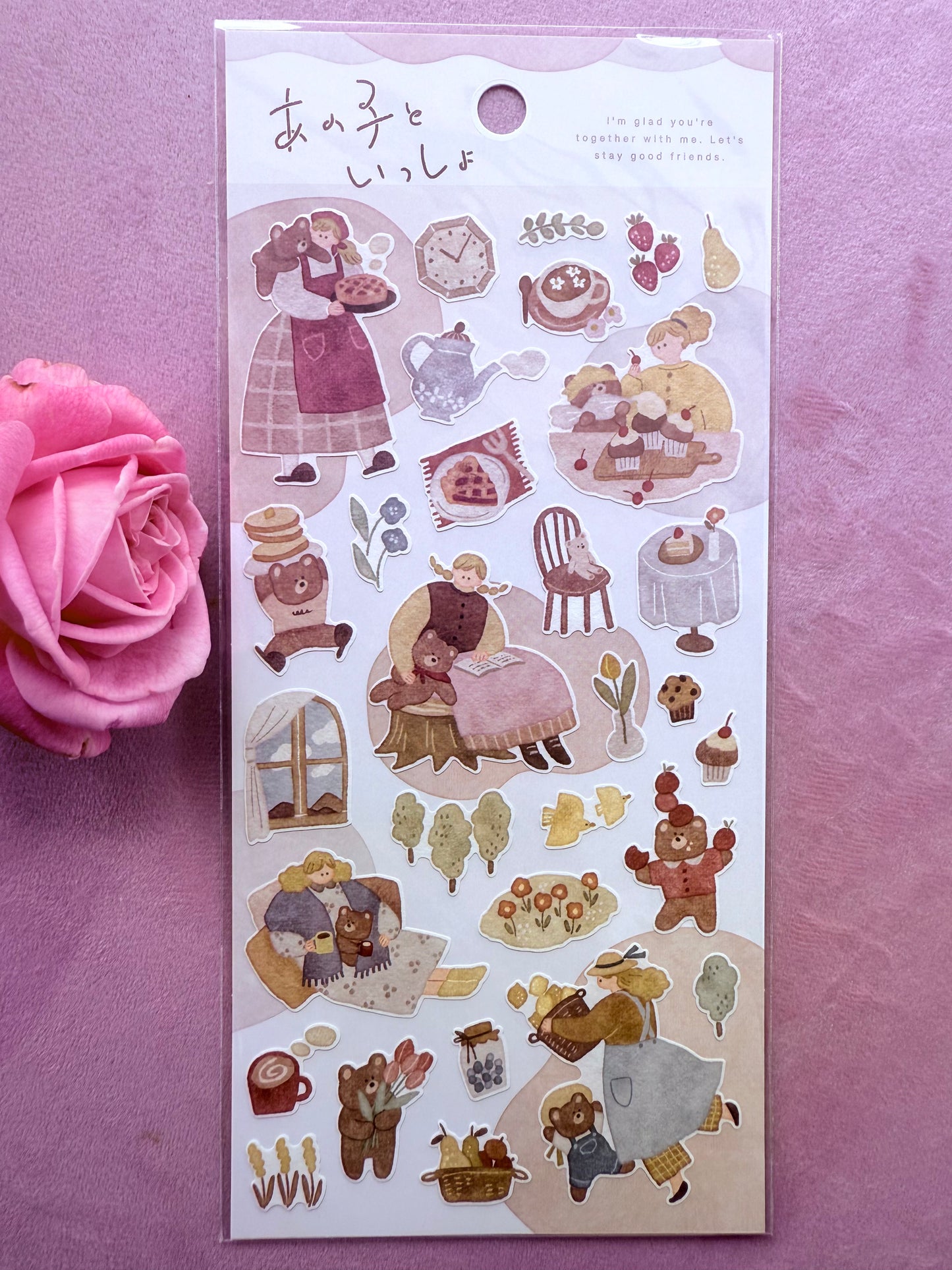 Sticker sheet with illustrations of a girl, teddy bear, and various objects on a pink background.