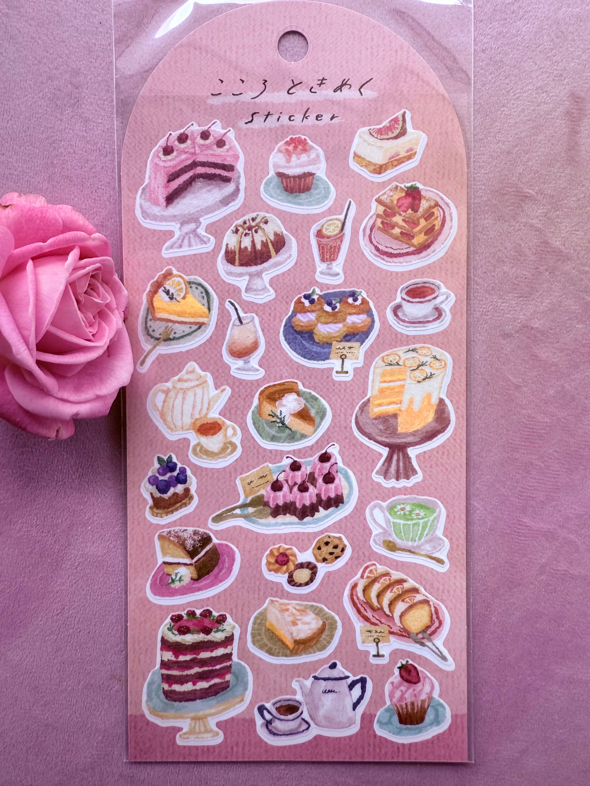 Sticker sheet with various food illustrations on a pink background with a pink rose.