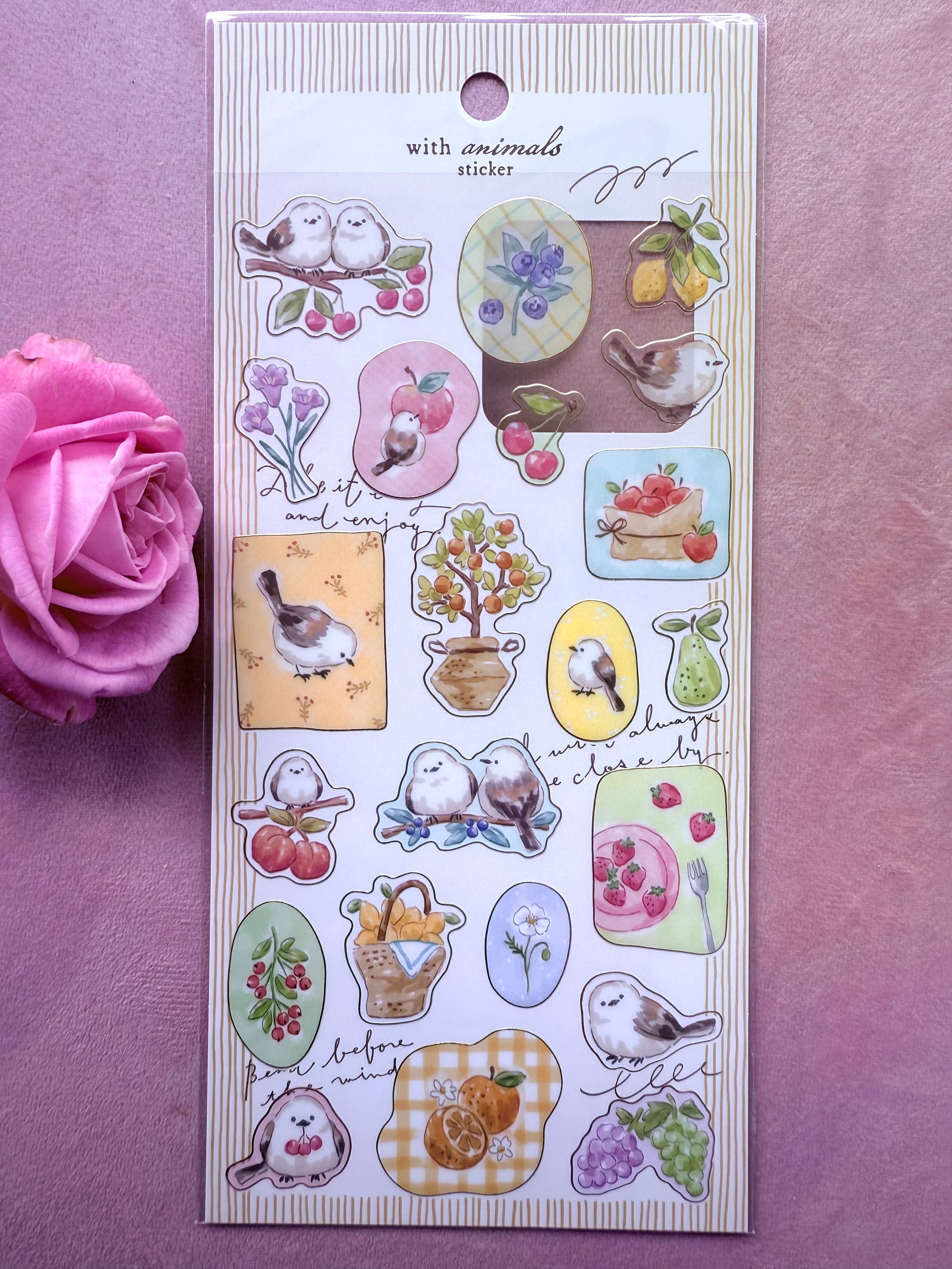Pack of decorative stickers with animal-themed designs on a purple background with a pink rose.