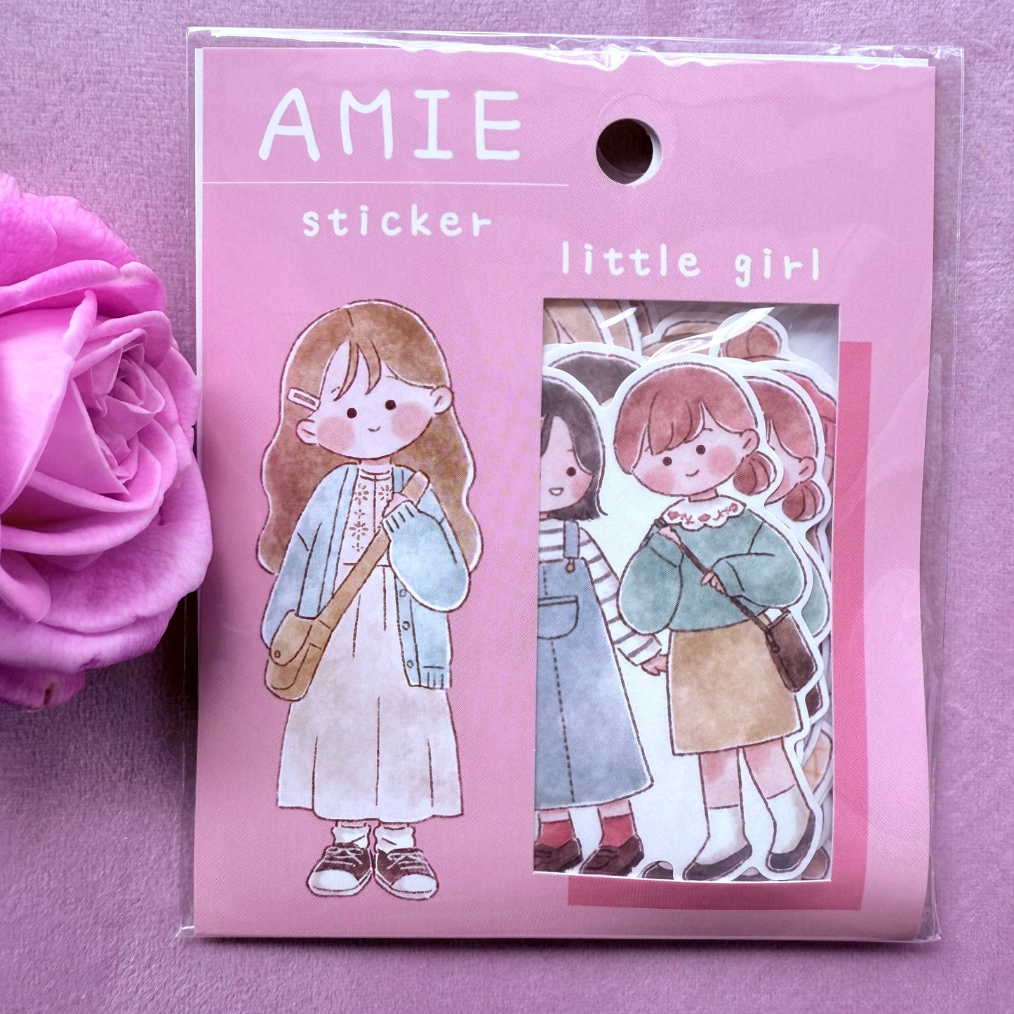 Sticker pack with illustrations of a 'little girl' on a pink background, featuring the brand 'AMIE'.