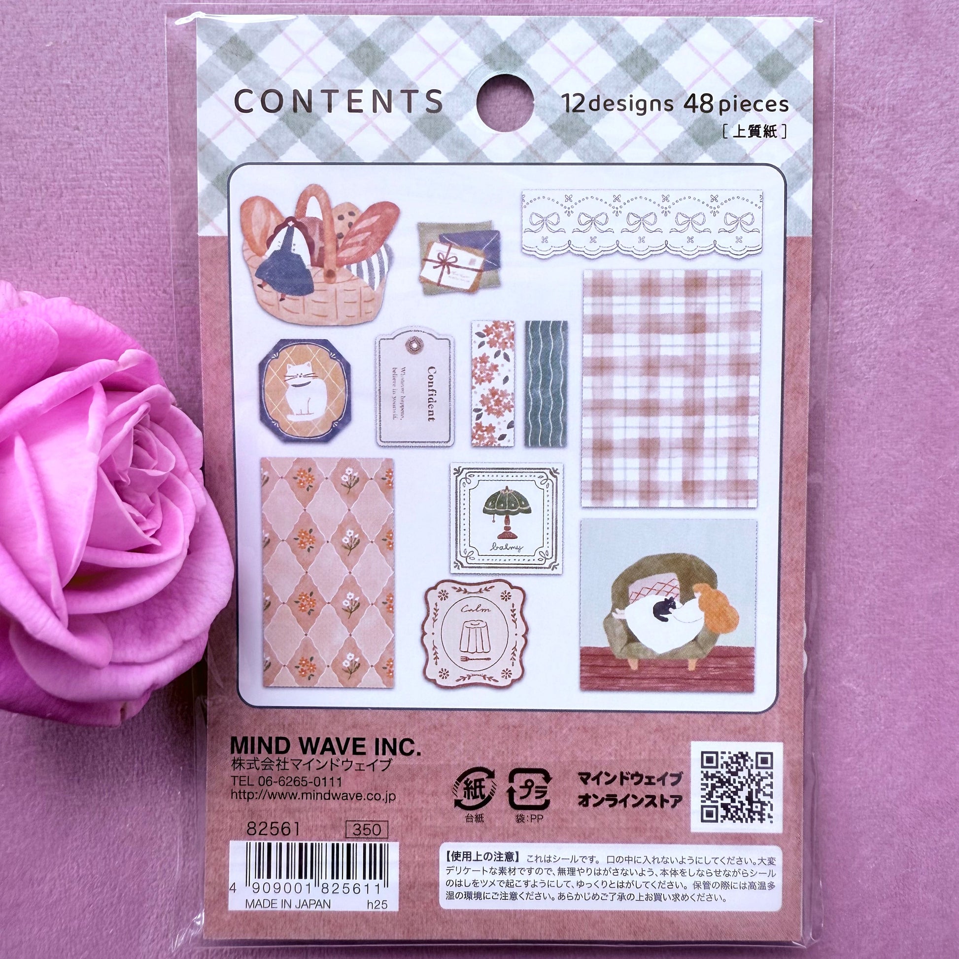 Packaged stamp set with designs on a purple background