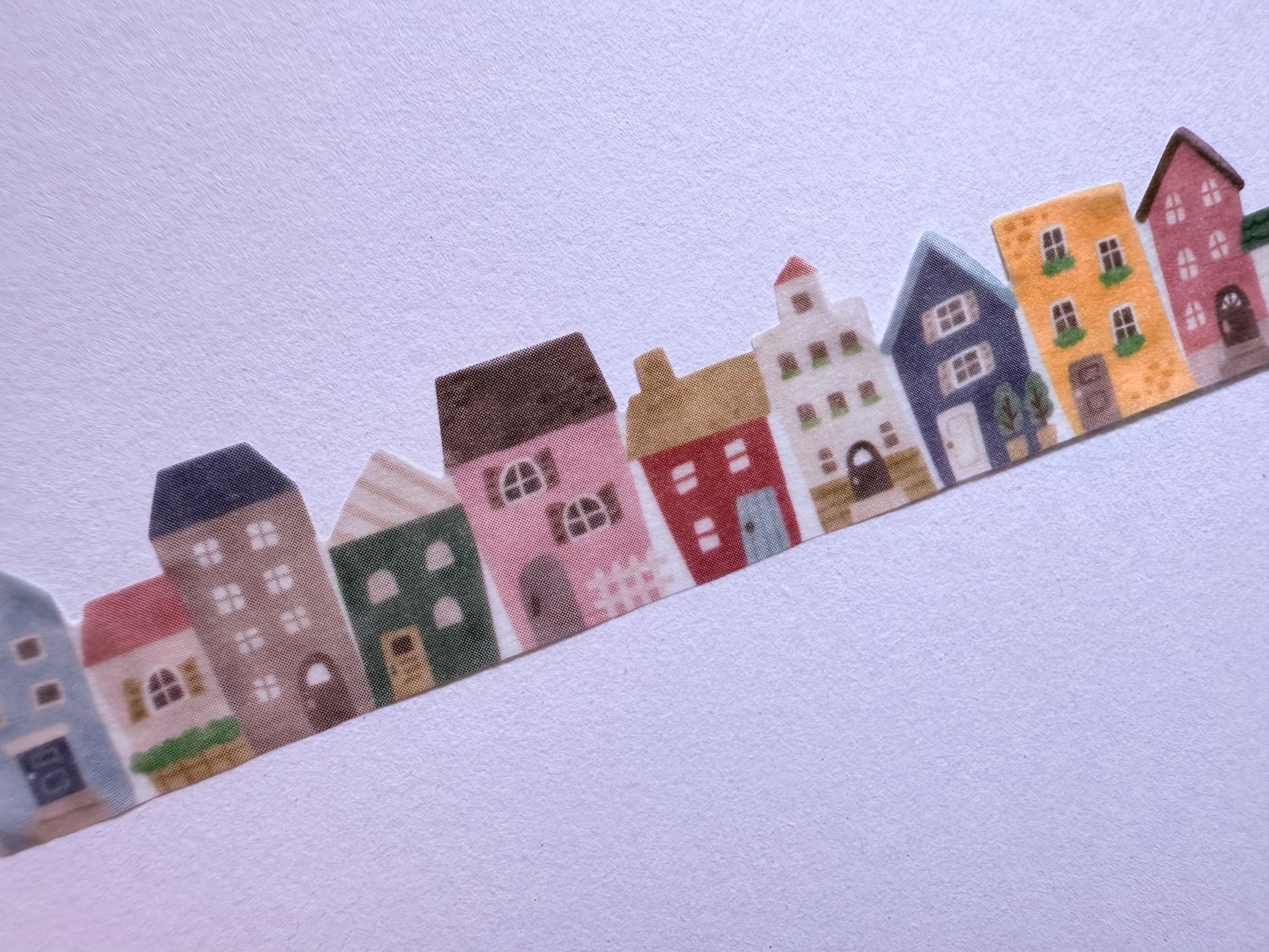 Row of colorful cartoon houses on a light blue background