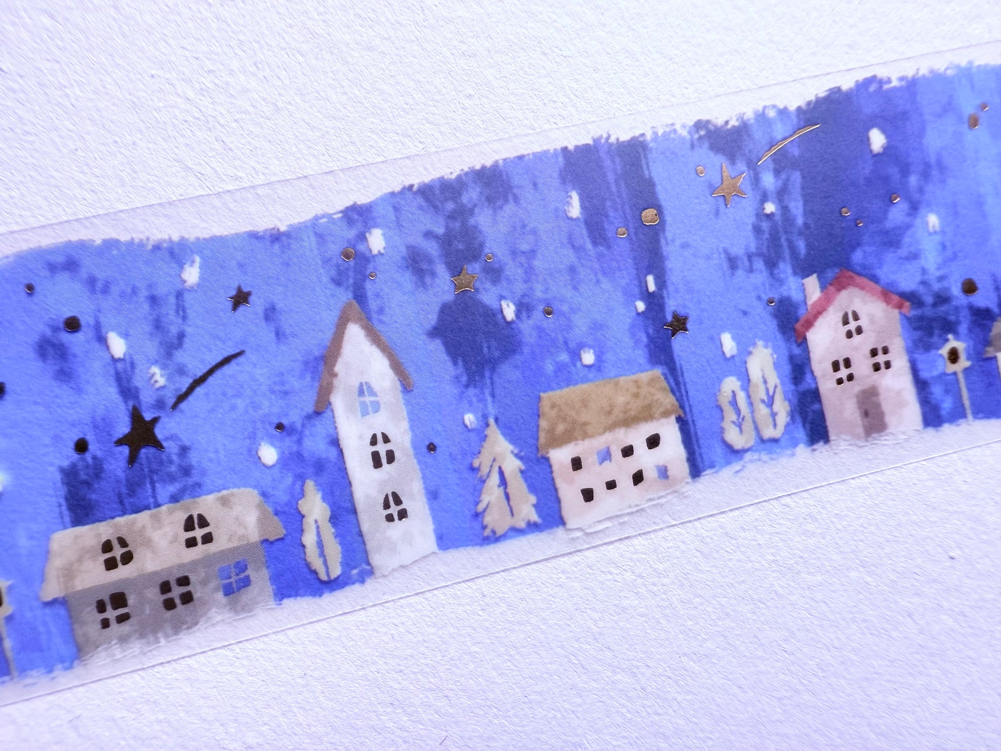 Decorative border with houses and stars on a blue background