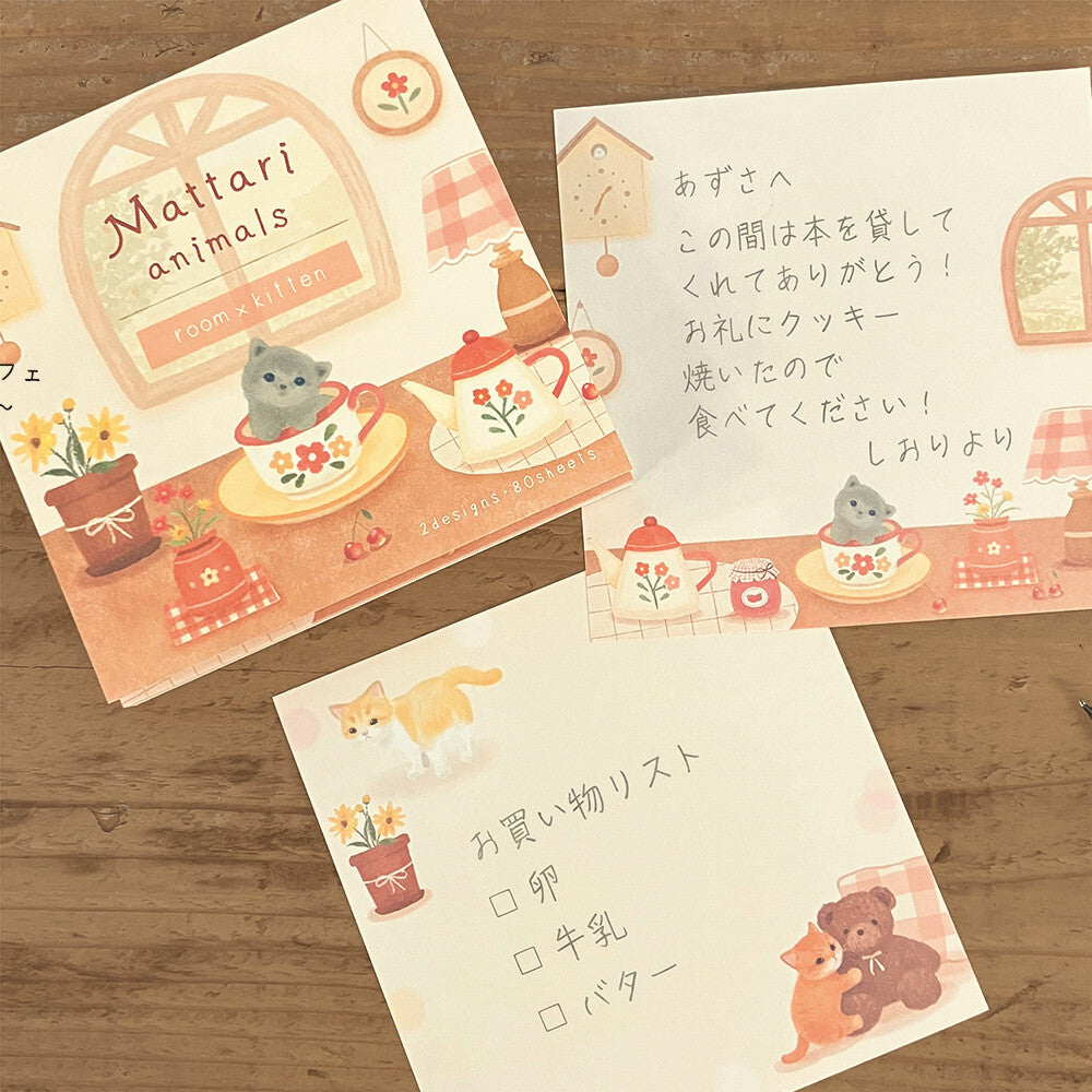 Three stationery items with animal-themed designs on a wooden surface