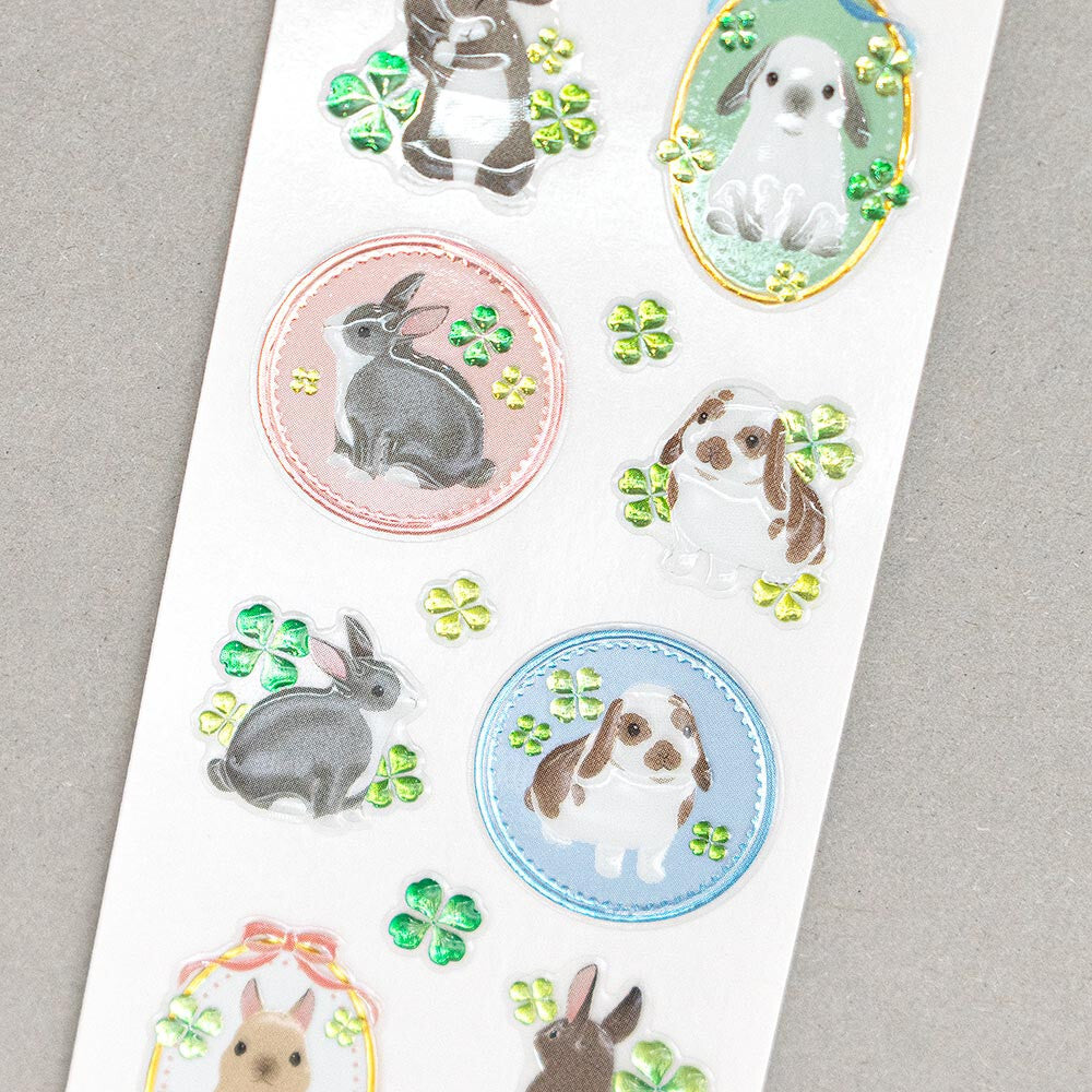 Sheet of rabbit-themed stickers with various designs on a gray background