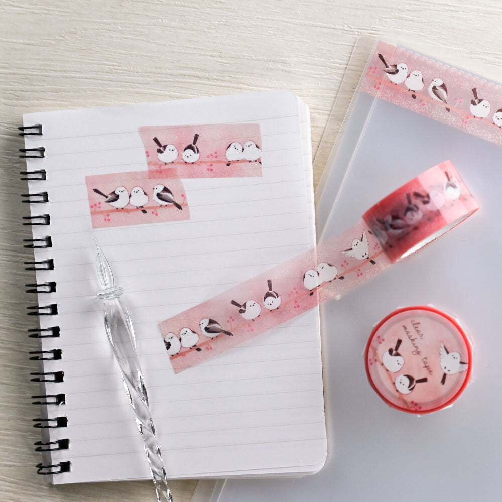 Notebook with decorative washi tape and stickers on a light wooden surface