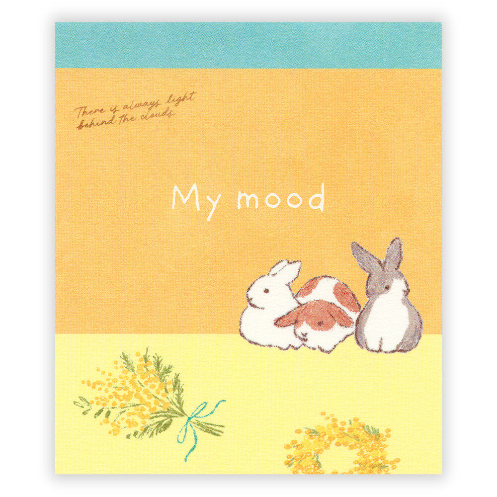 Notebook with cartoon bunnies and flowers on a yellow cover