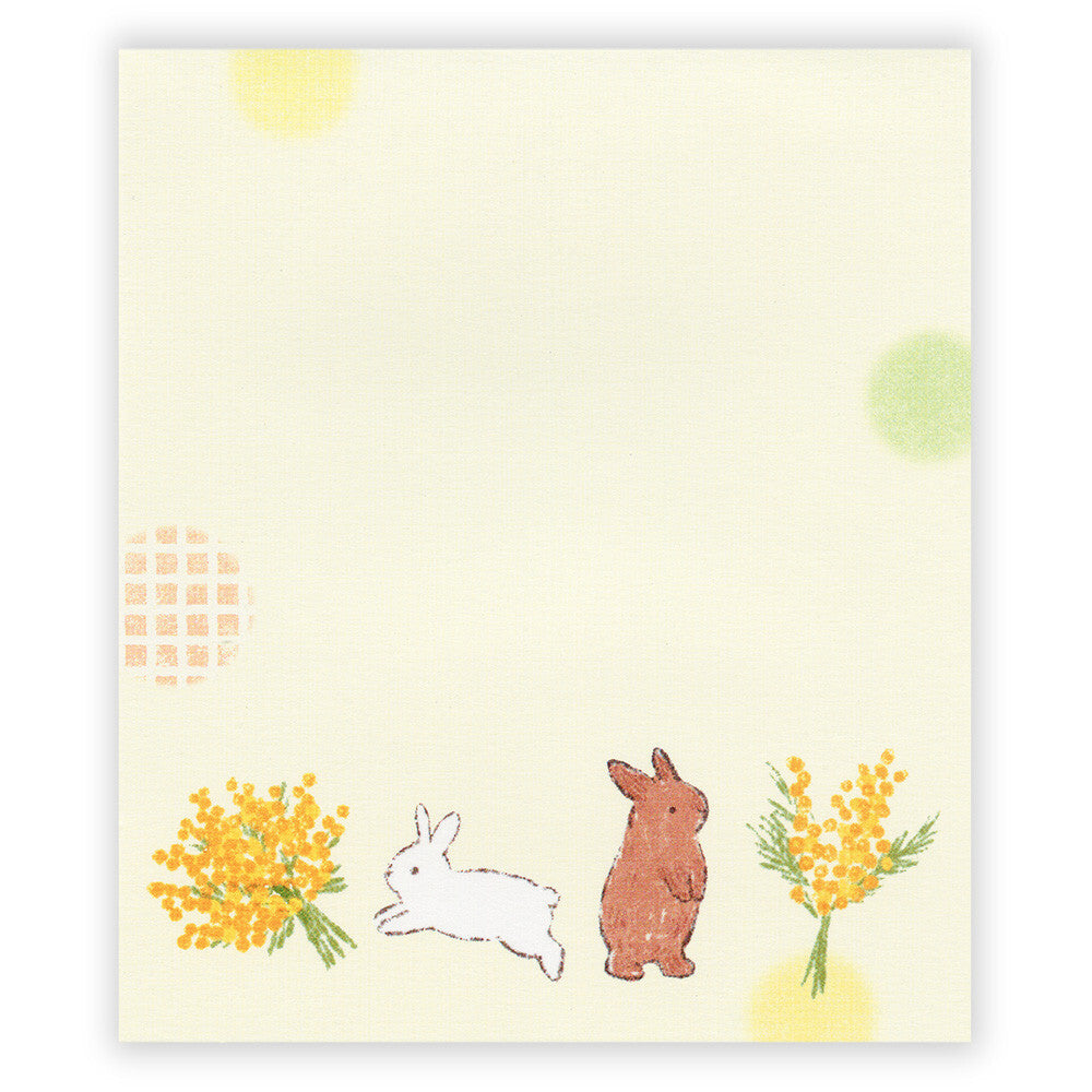 Notebook with illustrations of rabbits and yellow flowers on a light background