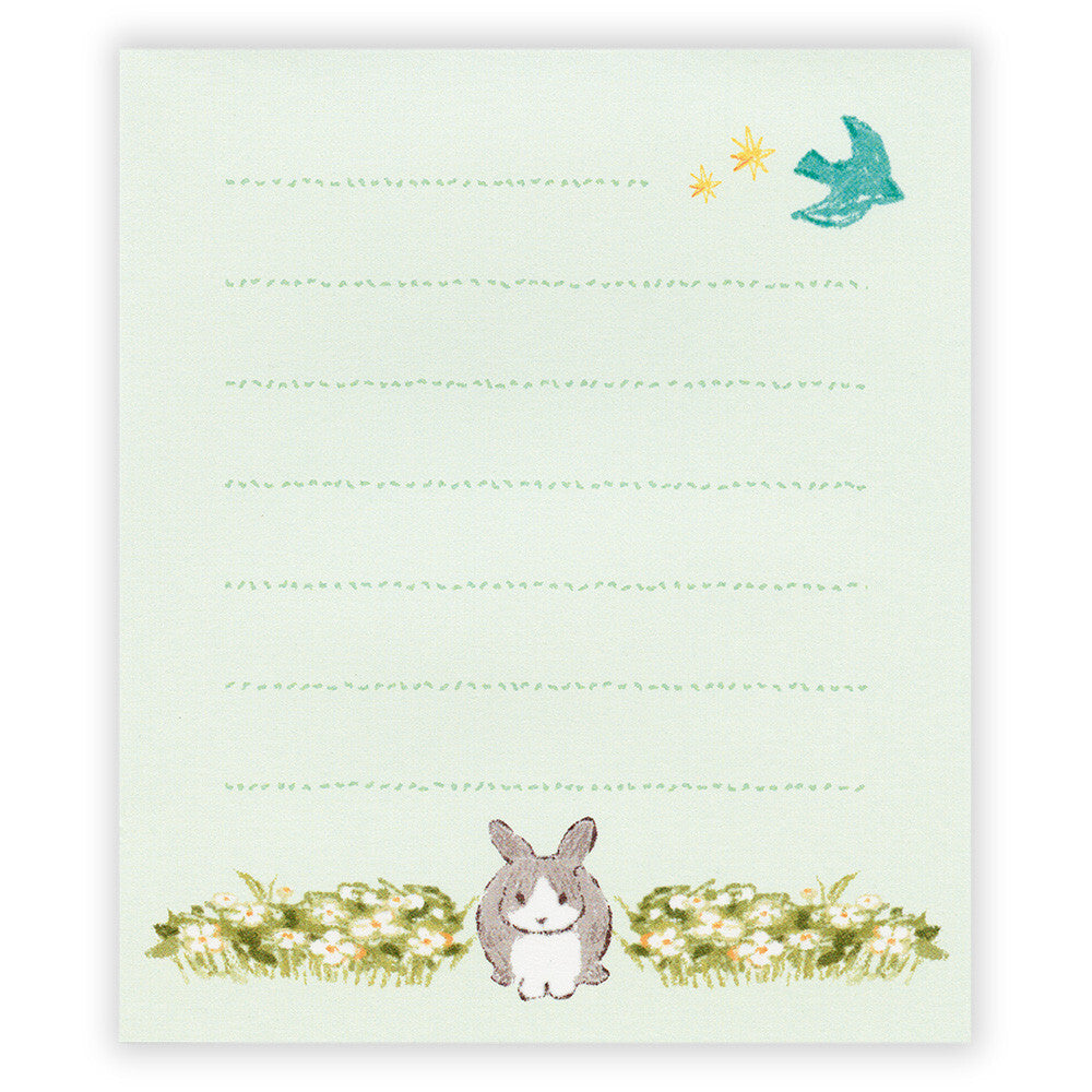 Notepad with a rabbit illustration and decorative elements on a light green background