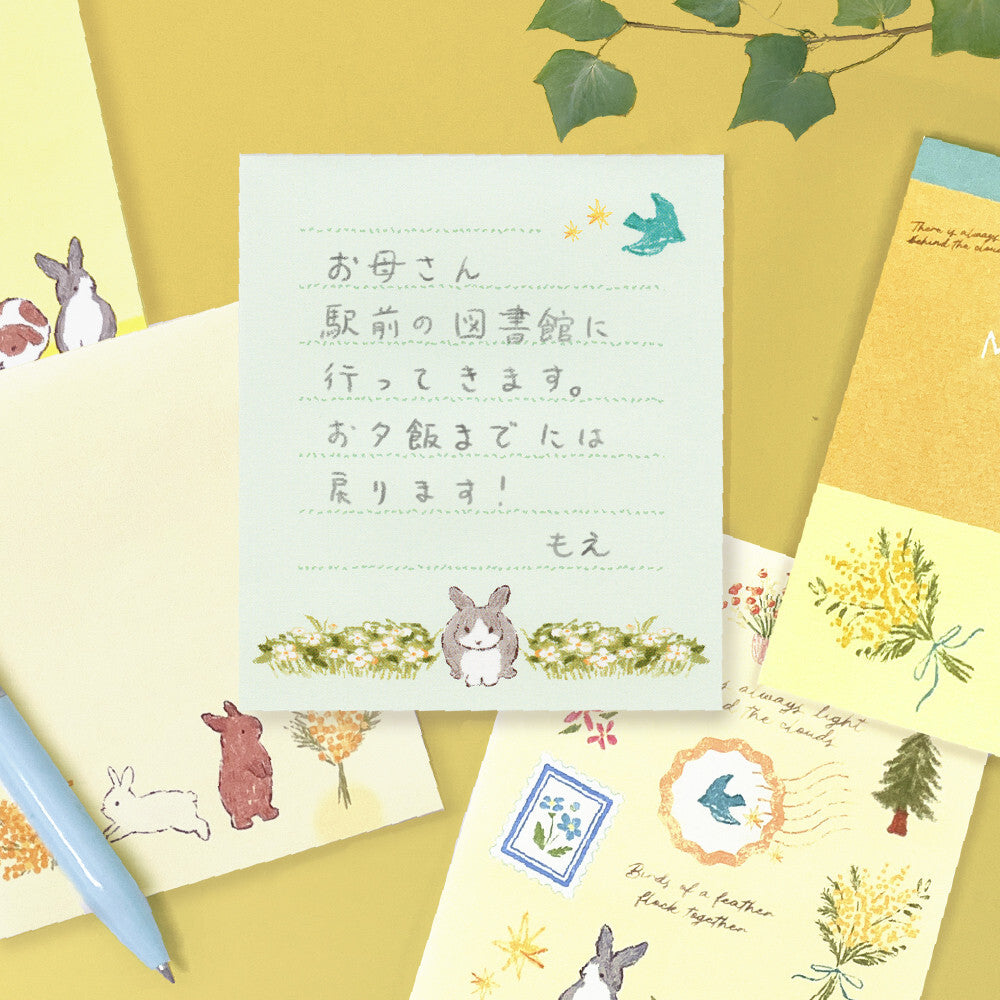 Set of stationery items with cute illustrations on a yellow background