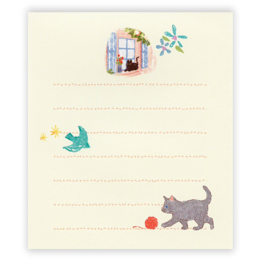 Notepad with illustrated cat, bird, and yarn on a light background