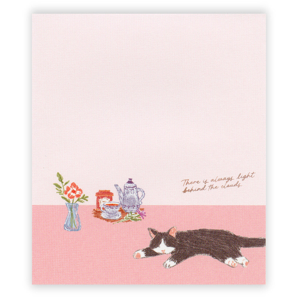 Notebook with a cat illustration and text on a pink background