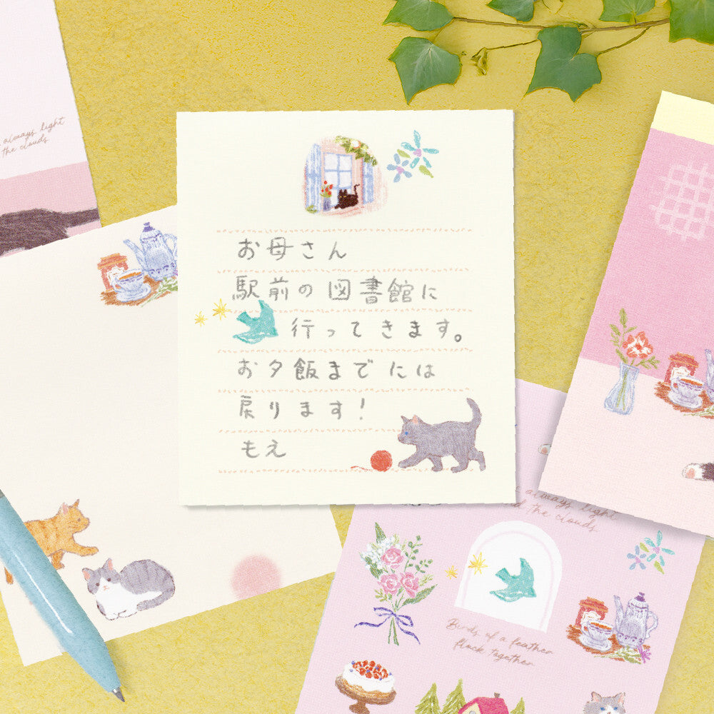 Set of illustrated cards with cute designs on a yellow surface