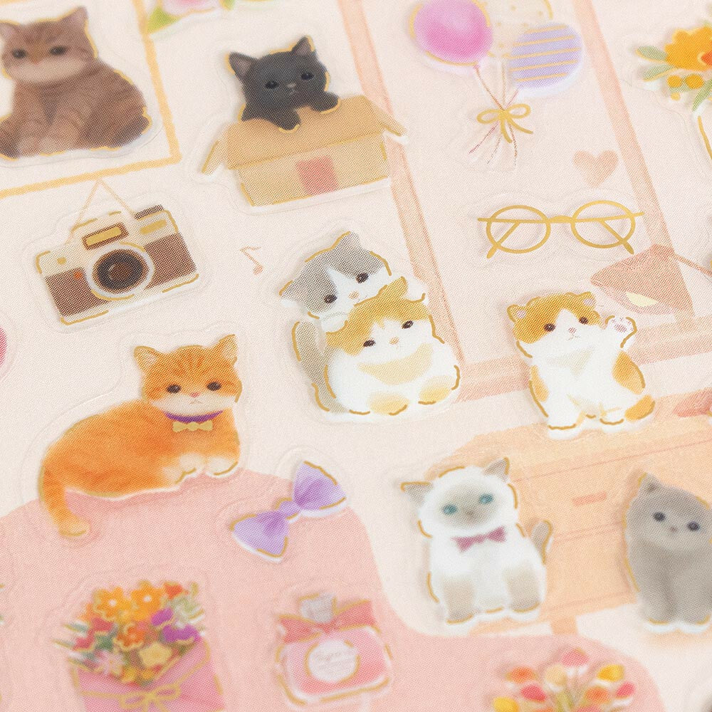 Collection of cute cat-themed stickers on a pink background