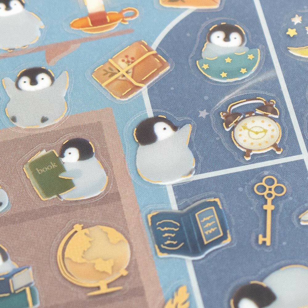 Illustrated pattern with penguins, books, a globe, and other items on a blue background