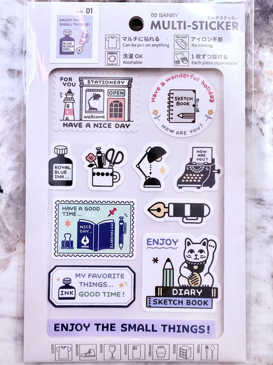Packaging of a set of stickers with various designs on a marble surface