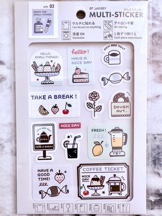 Packaging of a multi-sticker set with various illustrations on a marble surface