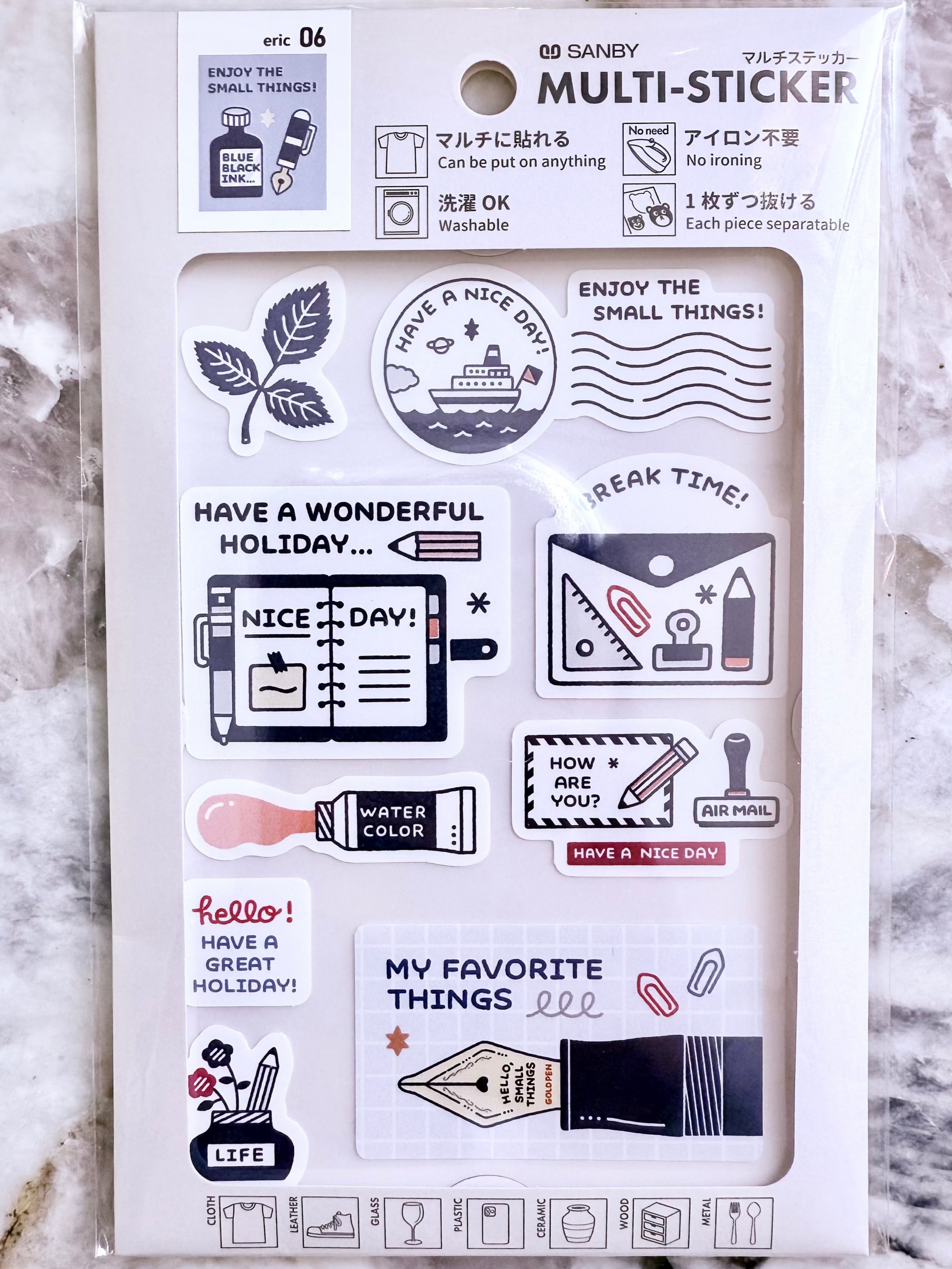 Packaging of MULTI-STICKER set on a marble surface