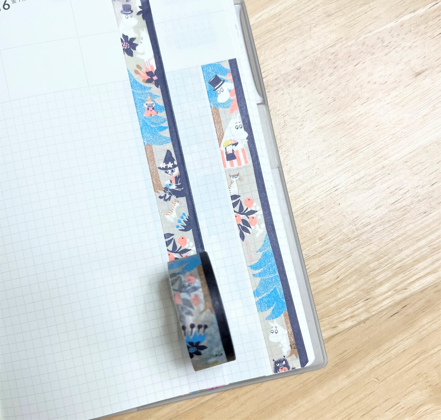 Decorative pen with floral and cat pattern on a notebook page