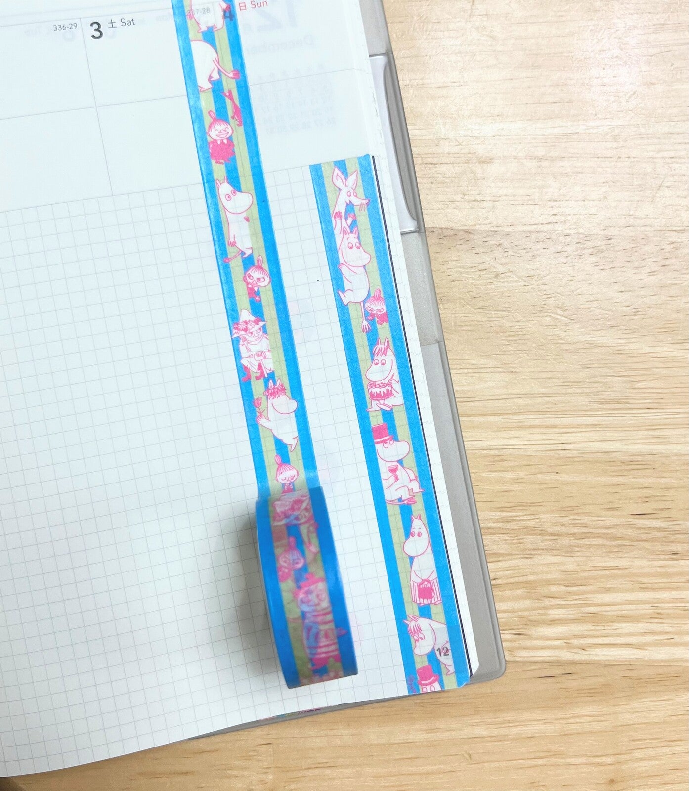 Decorative tape with cartoon characters on a notebook page