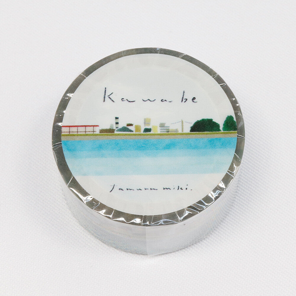 Round washi tape with a scenic design and text on a white background
