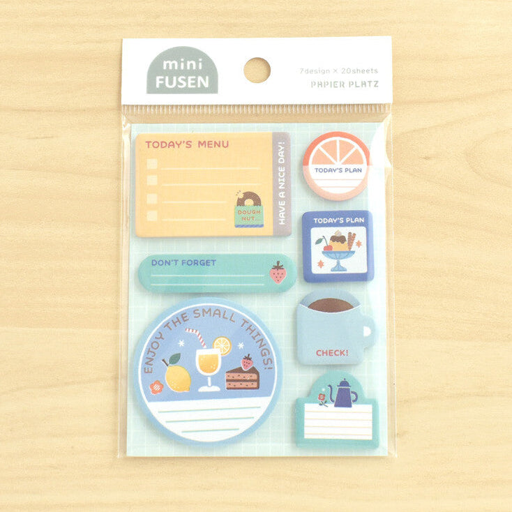 A packet of sticky notes on a wood background