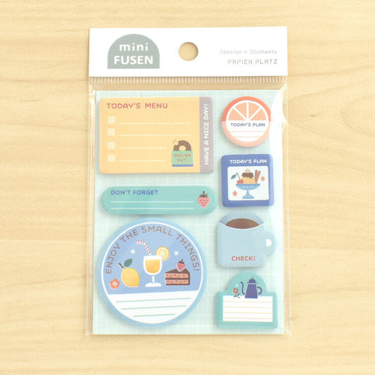A packet of sticky notes on a wood background
